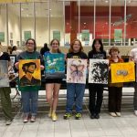 This photo features the seven student finalists and their finished paintings.
